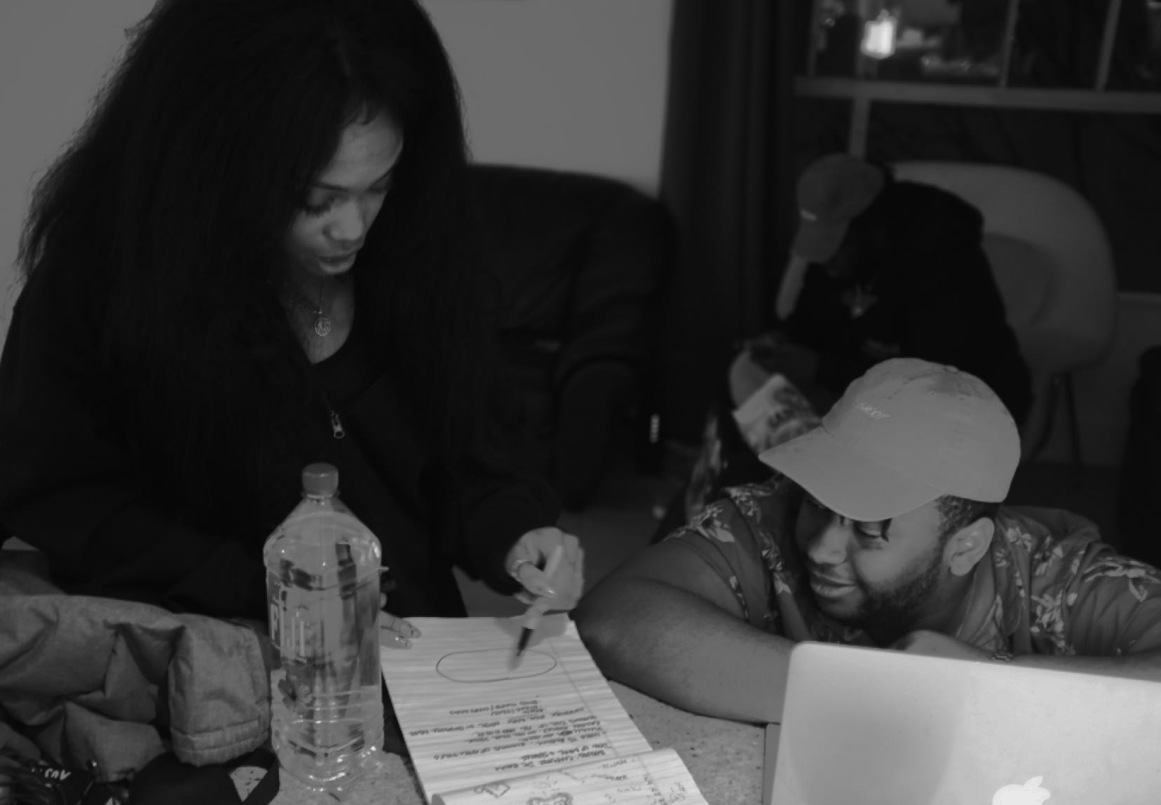 SZA working on a design on paper.